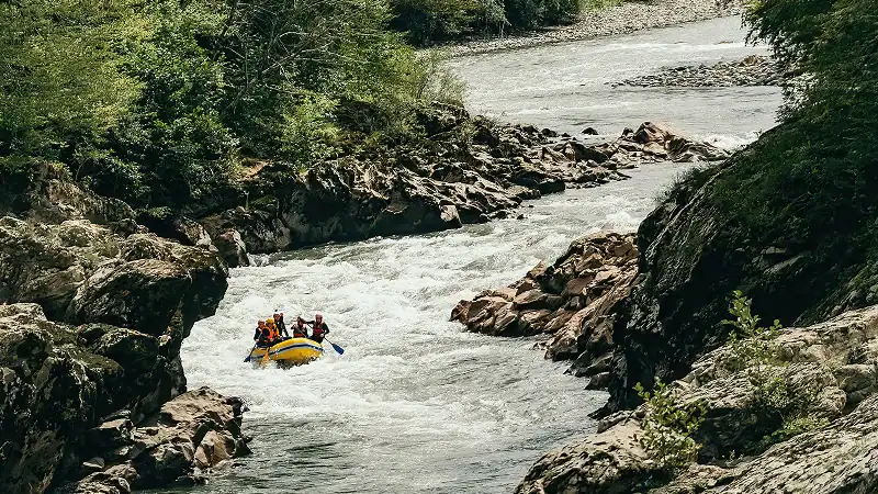 a group of people in a raft on a river