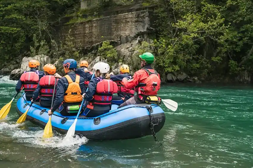 a group of people on a raft in the river